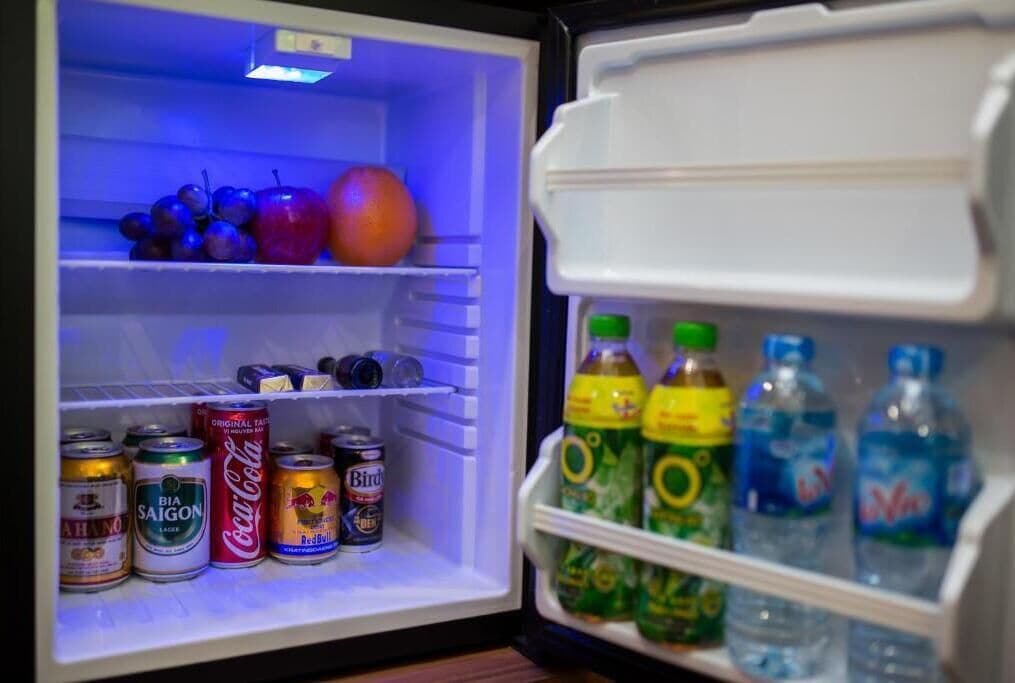 A refrigerator stocked with beverages and fruits.