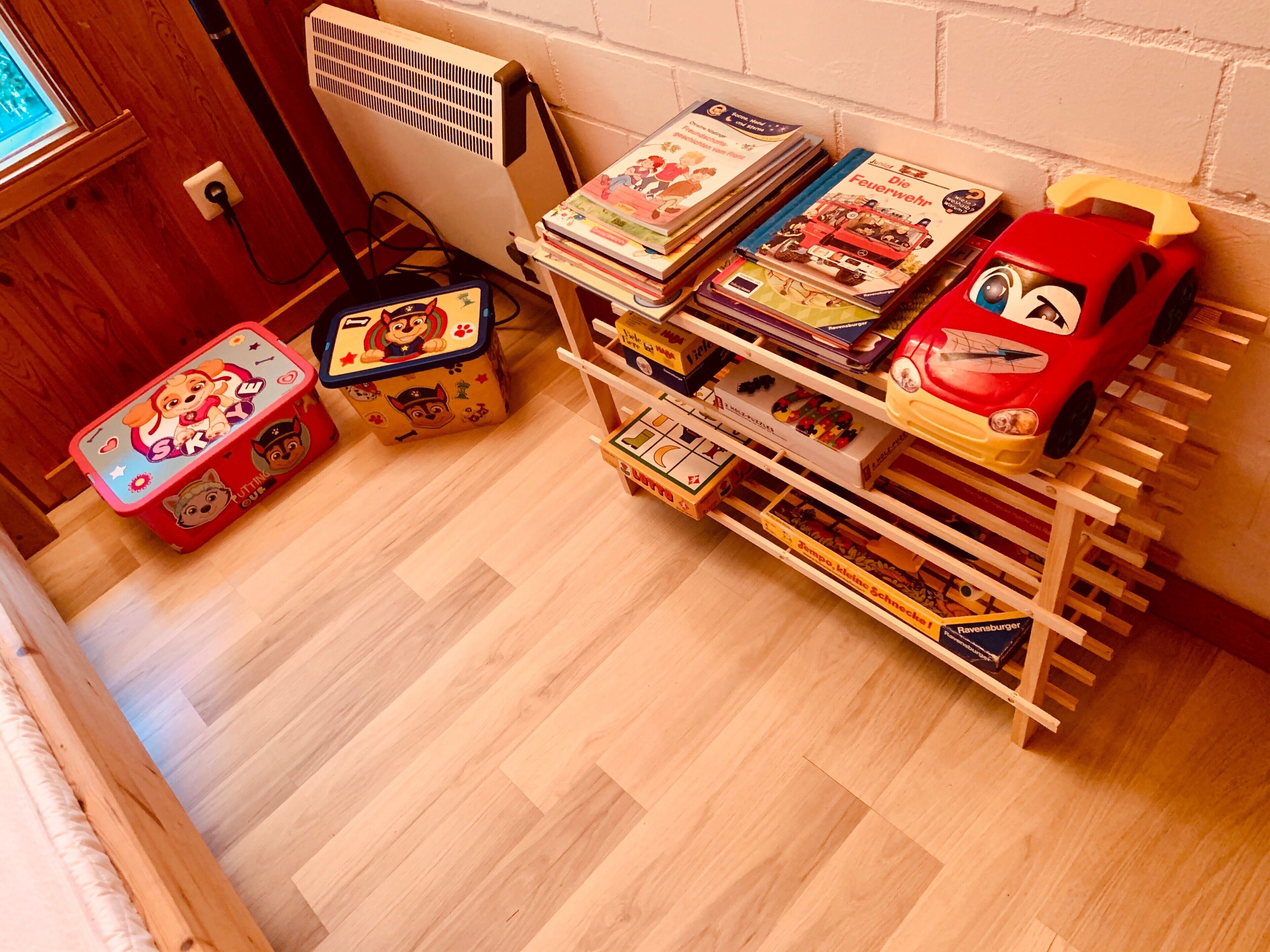 A child's play area with toys, books, and a toy car.