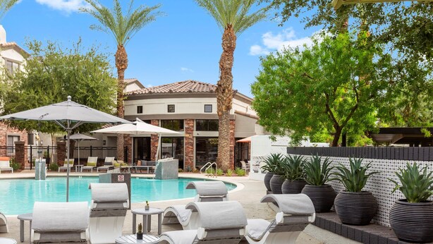 A poolside area with lounge chairs, umbrellas, and potted plants. - TWO Glendale CozySuites with Pool 2 & 9 (Glendale)