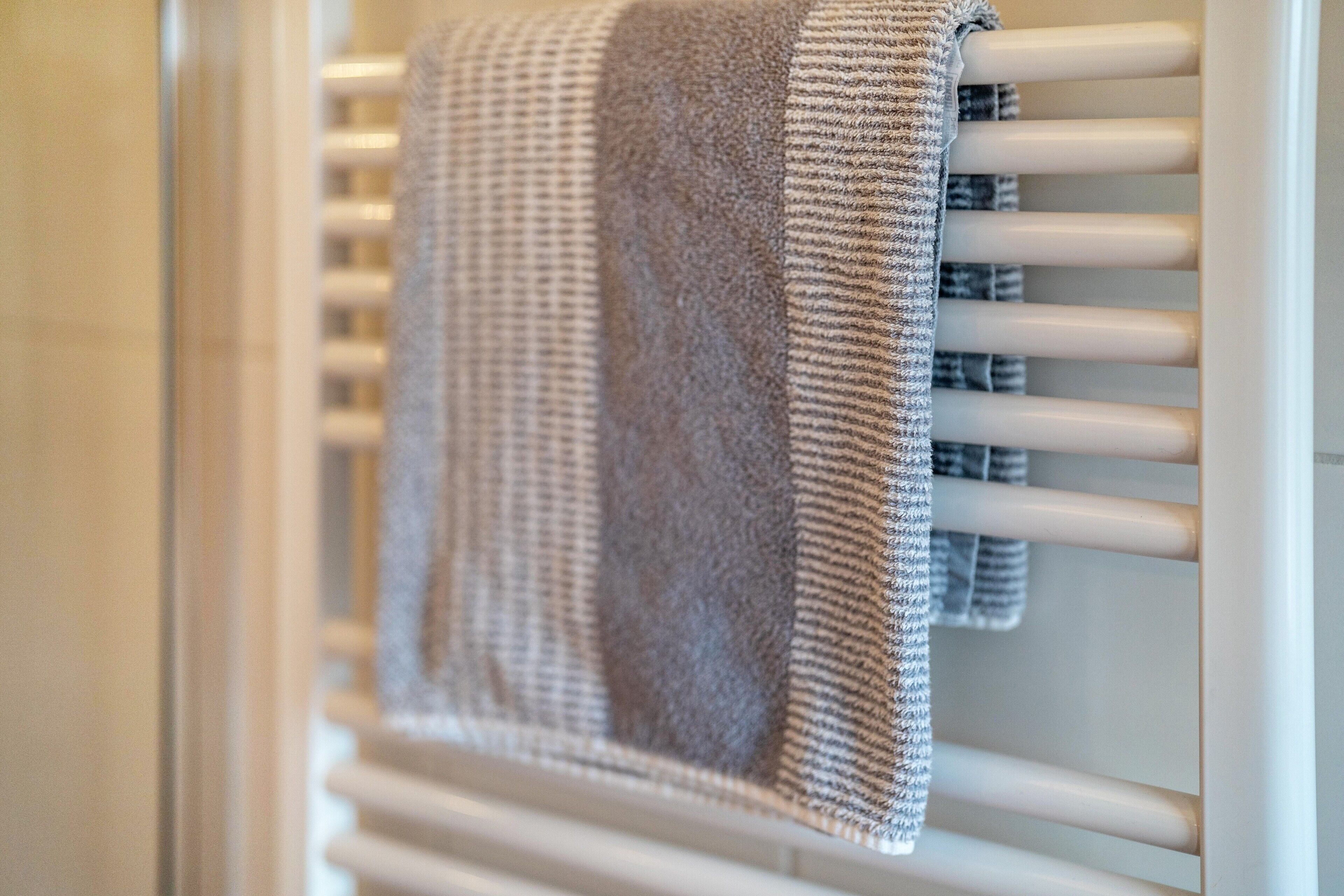 A towel rack with a folded towel.