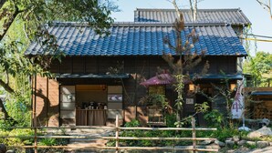 A traditional Japanese building with a tiled roof, wooden exterior, and a small entrance. - wood design park seto (Seto)