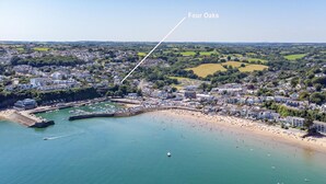 An aerial view of a coastal town with a beach, marina, and residential areas. - Four Oaks - Sea and Harbour Views (Saundersfoot)