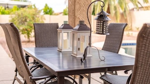 A patio table with four wicker chairs, two white lanterns, and a single black lantern. - NEW! Luxury, Scottsdale Getaway! (Scottsdale)