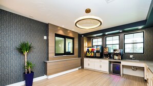 A modern kitchen with a built-in coffee machine, a refrigerator, and a sink. -  Palace Inn Blue Edgebrook (Houston)