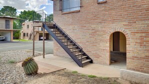 A brick building with a central staircase, a small arched entrance, and a cactus in the foreground. - Wildcats Welcome! Mtn-View Condo 7 Mi to U of A (Tucson)