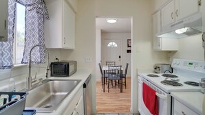 A compact kitchen with a sink, microwave, toaster, and stove. - Wildcats Welcome! Mtn-View Condo 7 Mi to U of A (Tucson)