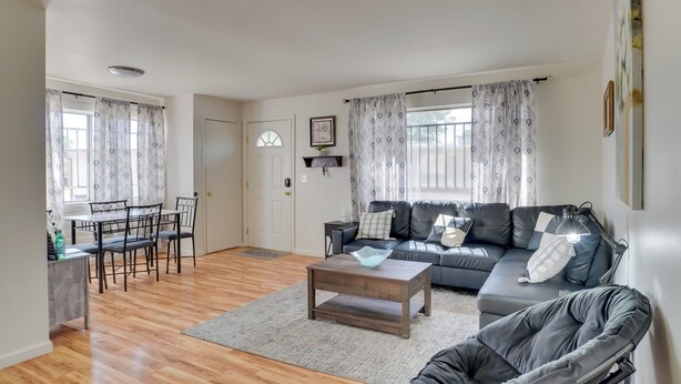 A living room with a sofa, chairs, a coffee table, and a dining area with a table and chairs. - Wildcats Welcome! Mtn-View Condo 7 Mi to U of A (Tucson)