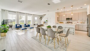 A modern kitchen with a central island, stainless steel appliances, and pendant lighting. - Four Corners Townhome w/ Pool Access Near Disney! (Four Corners)