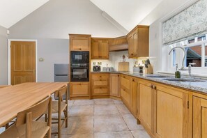 Enjoy meals in this well-equipped kitchen with oven, microwave, and sink.
