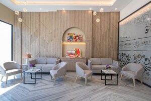 A modern living room with sofas, coffee tables, and artwork on the wall.