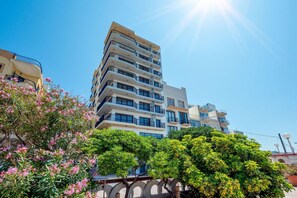 Residents enjoy balconies with outdoor space amidst lush greenery and a serene atmosphere.