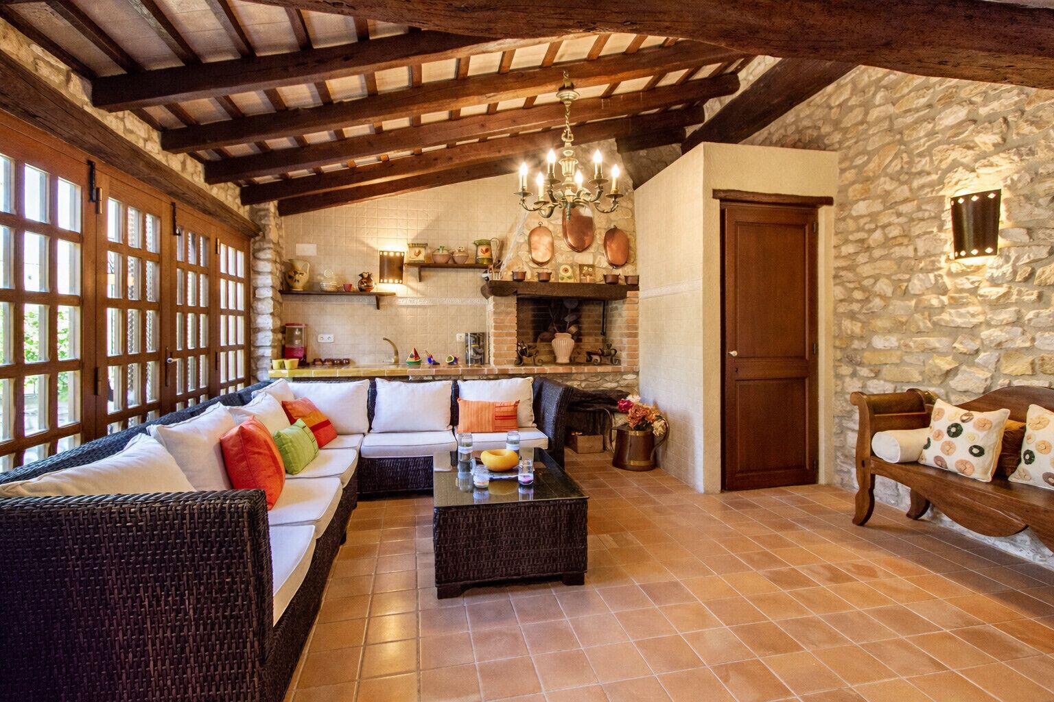 Una sala acogedora con un sofá, una mesa de centro y paredes de piedra.