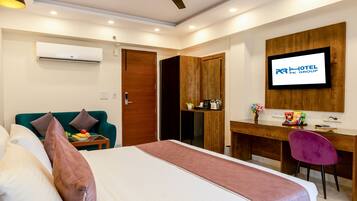 A hotel room with a bed, a desk, a TV, and a ceiling fan.
