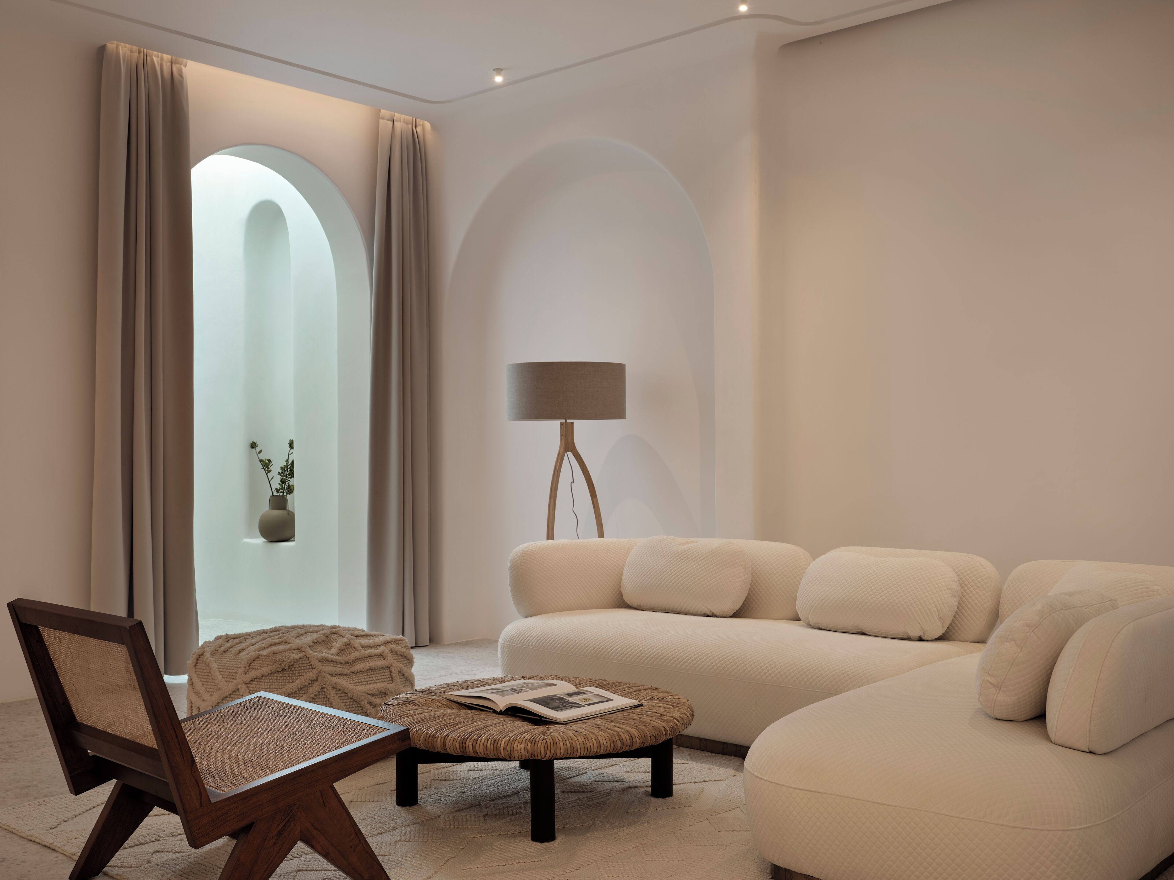 A modern living room with a sofa, a chair, a coffee table, and a floor lamp.