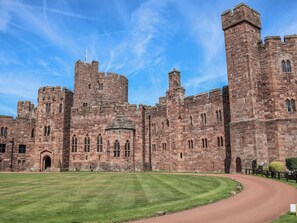 A large historic stone castle with multiple towers and arched windows. - 1 Fountain Cottages (Tarporley)