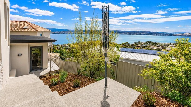A residential property with a view of a lake, a solar panel, and a metal sculpture. - View Studio | Derwent River Views | Sandy Bay (Sandy Bay)