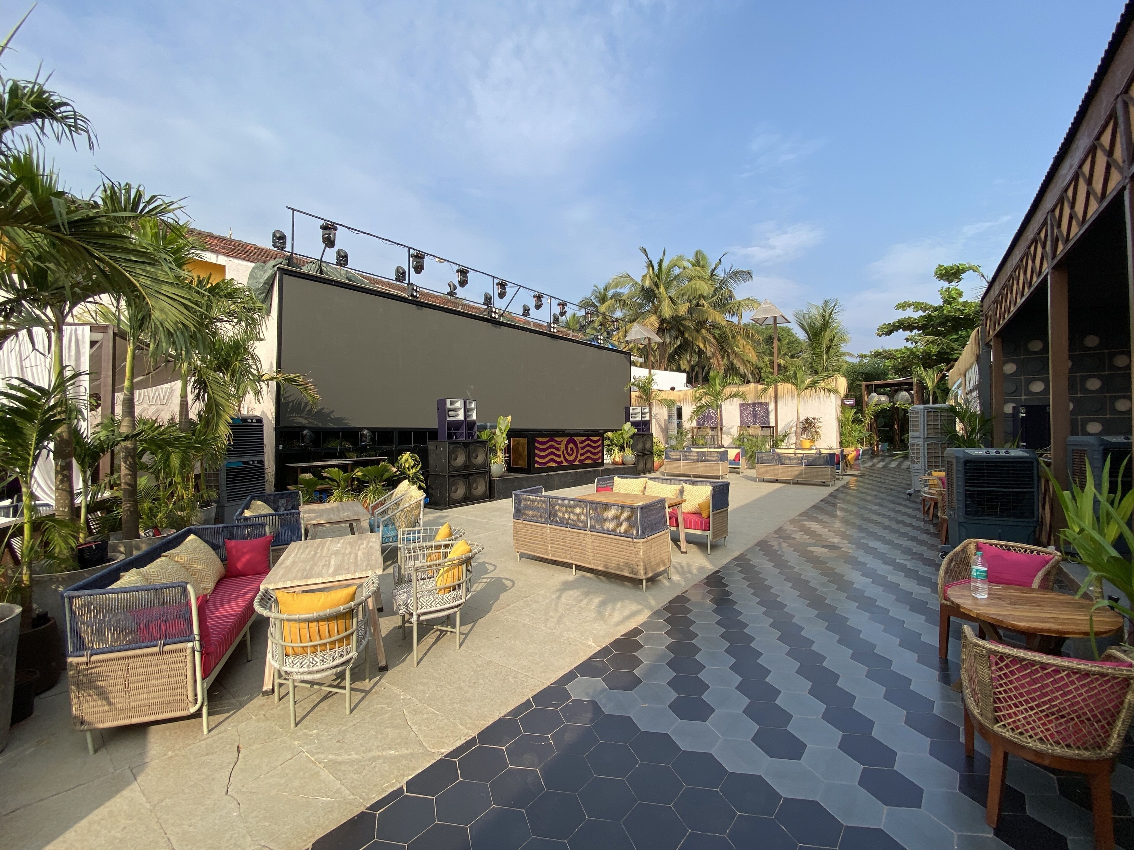An outdoor seating area with wicker furniture and a tiled floor.