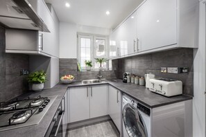 A modern kitchen with a gas stove, a dishwasher, and a built-in oven.