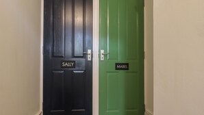 Two doors with nameplates, one labeled "SALLY" and the other "MABEL". - Sally (Whitstable)