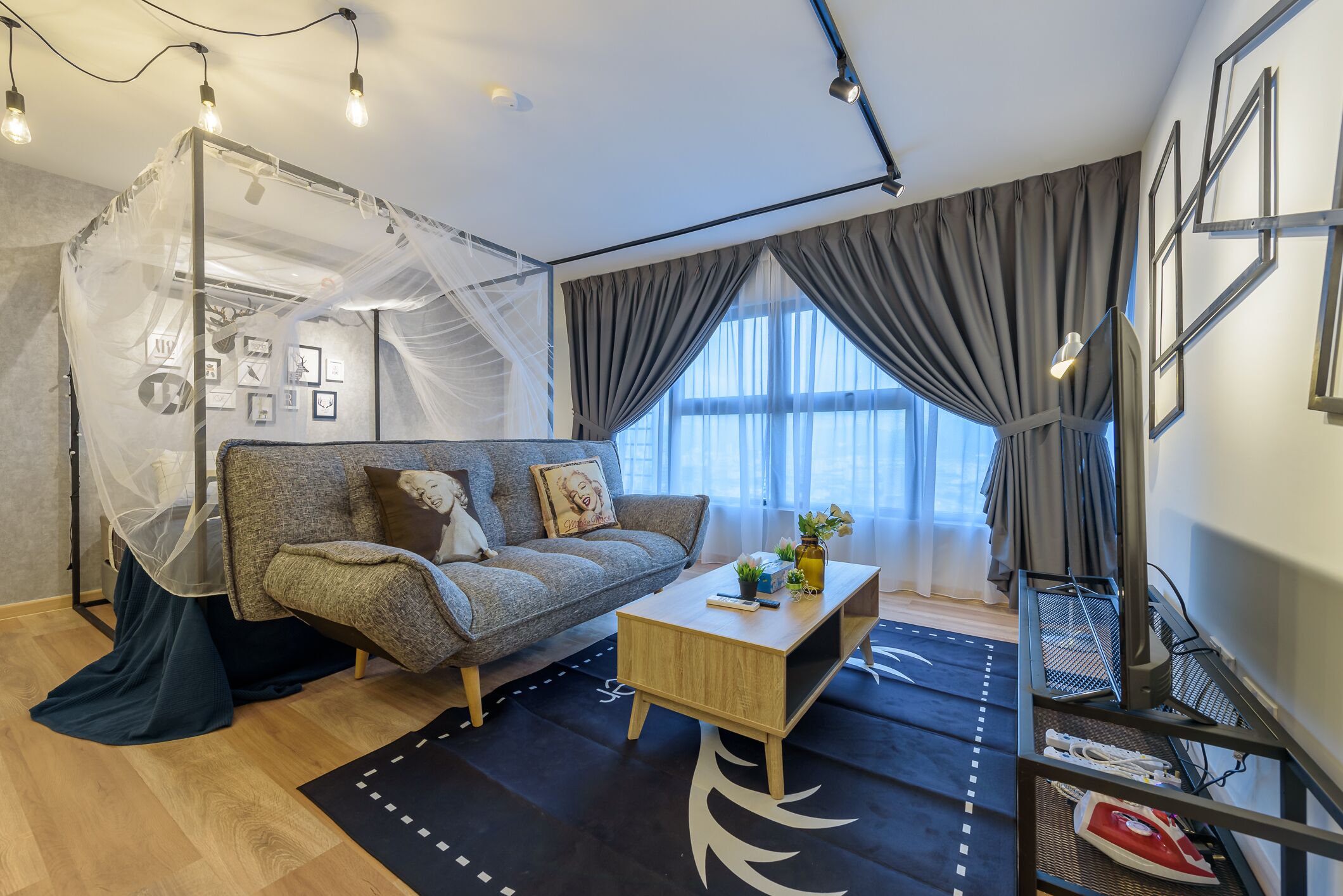 A modern living room with a sofa, coffee table, and a decorative canopy.