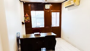 Ein Flur mit Deckenventilator, einer Holztür und einem Fenster mit Jalousien.