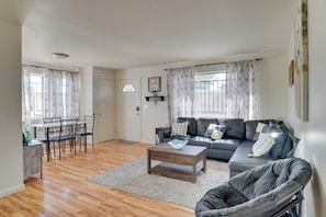 A living room with a sofa, chairs, a coffee table, and a dining area with a table and chairs. - Wildcats Welcome! Mtn-view Condo 7 Mi to U of A (Tucson)