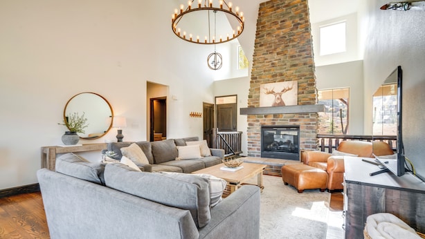 A modern living room with a fireplace, leather sofas, and a stone accent wall. - Half-mi to Skiing: Gorgeous Granby Ranch Home! (Granby)