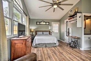 A bedroom with a bed, wooden dresser, vanity, sewing machine, and a ceiling fan. - Studio w/ Patio - Walk to Hikes, Sights & Bites (Aberdeen)