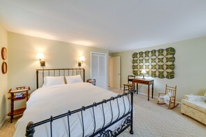 Cozy retreat with a large bed, nightstand, and comfortable seating area.