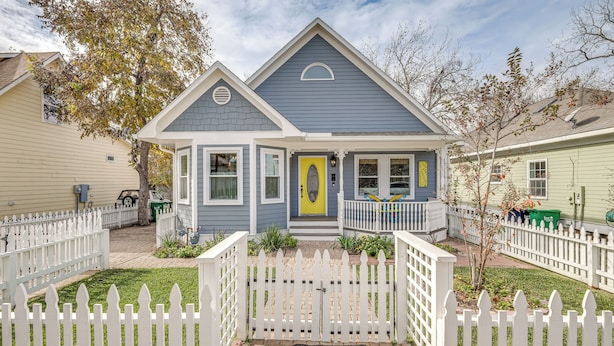 A two-story house with a gabled roof, a front porch, and a white picket fence. - Brenham Rental w/ Deck & Yard < 1 Mi to Downtown! (Brenham)