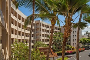 A multi-story hotel with balconies and palm trees. - Royal Mauian 512 2 Bedroom Condo (Kihei)