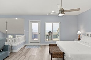 Relax in this serene single-bedroom suite with a large bed, ceiling fan, and balcony.
