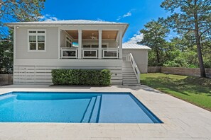 A two-story house with a covered porch, a swimming pool, and a staircase leading to the upper level. - The Gulf Pearl on 30A - 4B/4.5B Private Pool / 6-Seater Golf Cart (Santa Rosa Beach)