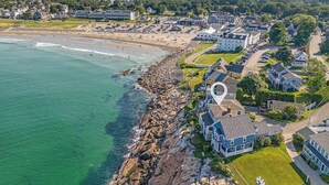 An aerial view of a coastal town with a beach, houses, and a large building. - Overlook Beach House #4- York Maine Beach Rental (York)