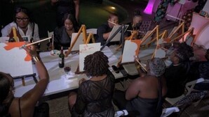 A group of people engaged in an art activity outdoors, seated at tables with easels and canvases. - Reef Utopia Tobago Private Beautiful Villa,3mins Walk to Beach,Great Pool,Garden (Tobago)