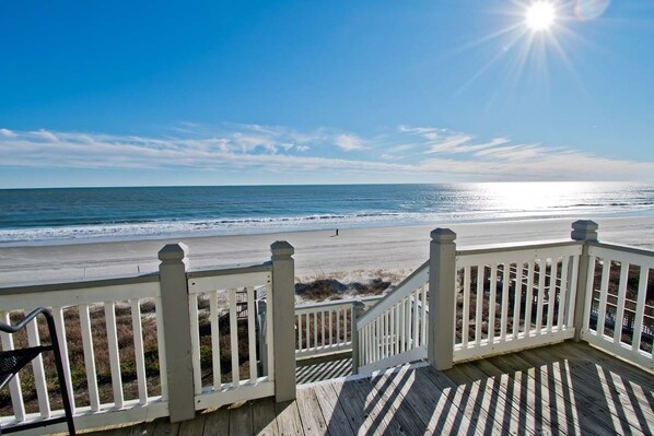 A wooden deck with white railings overlooking a beach. - Pier Pointe 1A3, Oceanfront Condo in Emerald Isle, NC! (Emerald Isle)