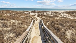 A wooden boardwalk leading to a beach with dunes and a clear sky. - Point Emerald A-205, Oceanfront Condo in Emerald Isle, NC! (Emerald Isle)