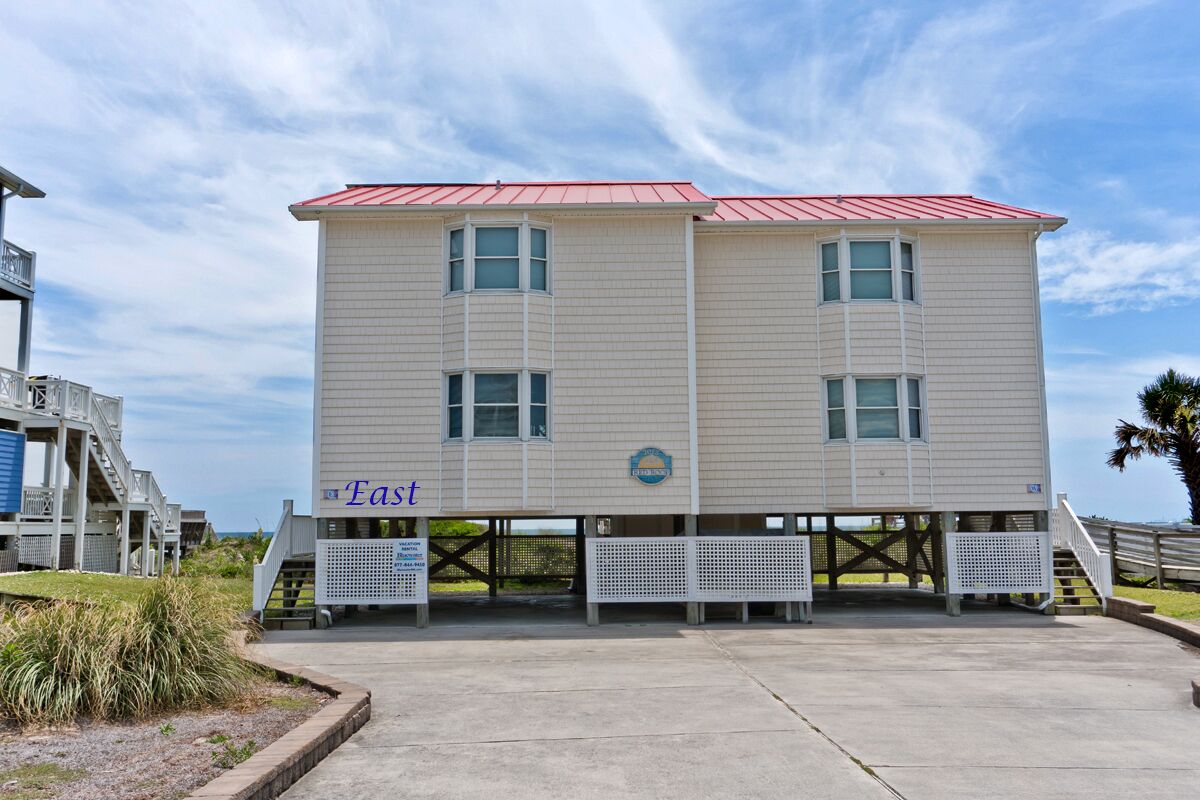 A two-story building with a red roof, labeled "East" on the lower level.