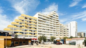 A multi-story hotel with balconies, a central courtyard, and a fountain. - Praia da Rocha Wonder w/ Balcony by LovelyStay (Praia da Rocha)
