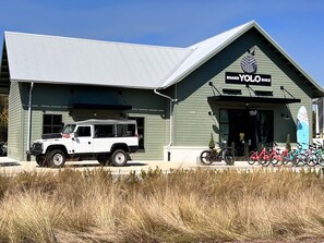 A building with a sign reading "Board Yolo Bike".