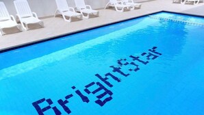 A swimming pool with the word "Brightstar" written in the water. - Residence Bright Star two-room apartment Executive for 6 people (Bibione)