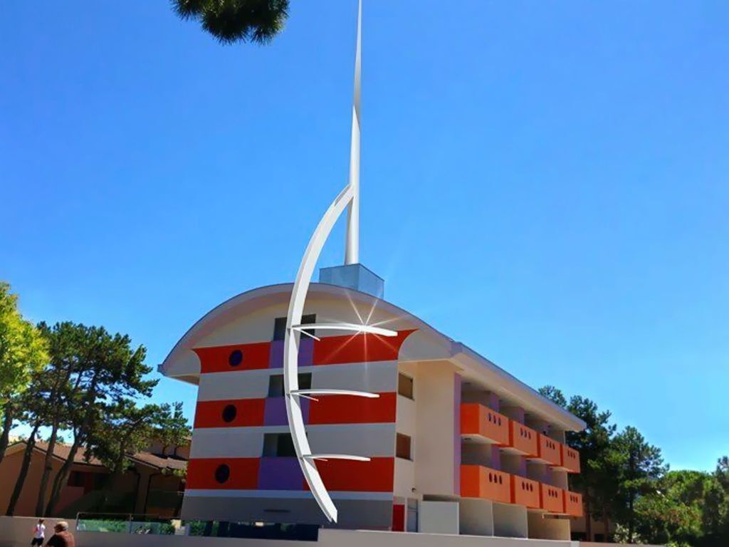 A modern building with a curved roof and a tall white spire.