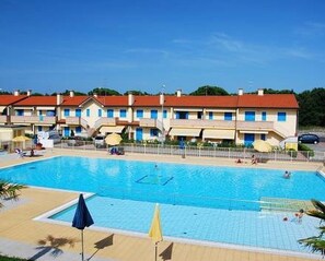 Relax by the hotel's large pool surrounded by a shaded deck area.
