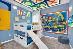 A child's bedroom with bunk beds, a slide, and a large wall mural. - Last Minute Disney! Private Pool, Game Room & Themed Bedrooms. Book Now! #38884 (Orlando)
