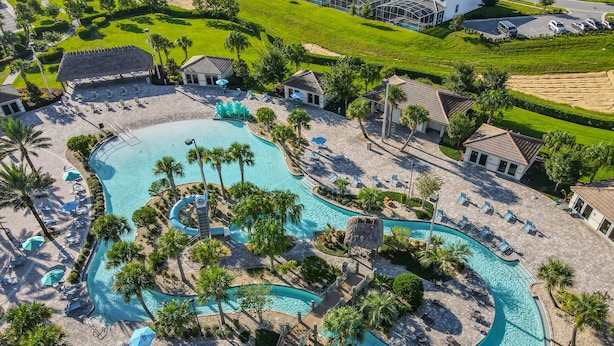 An aerial view of a resort with multiple swimming pools, sun loungers, and palm trees. - Last Minute Disney Getaway! Townhouse with Private Pool. Book Now! #87939 (Orlando)