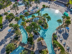 An aerial view of a resort with a central swimming pool, surrounded by palm trees and lounge areas. - Last Minute Disney Getaway! Private Pool & Game Room. Book Now! #88071 (Orlando)