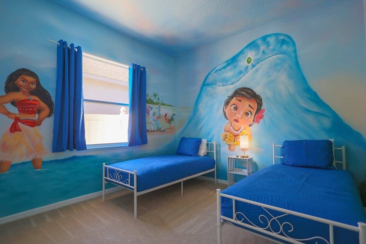 A child's bedroom with two beds, a mural of a whale, and a window with curtains.