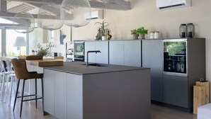 A modern kitchen with a central island, pendant lights, and a built-in refrigerator. - Villa in Terontola with 3 bedrooms sleeps 6 (Terontola)