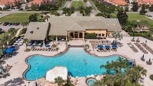 A resort with a large pool, sun loungers, and a well-maintained lawn. - Last Minute Disney Getaway! Private Pool, Hot Tub & Game Room. Book Now! #82571 (Orlando)