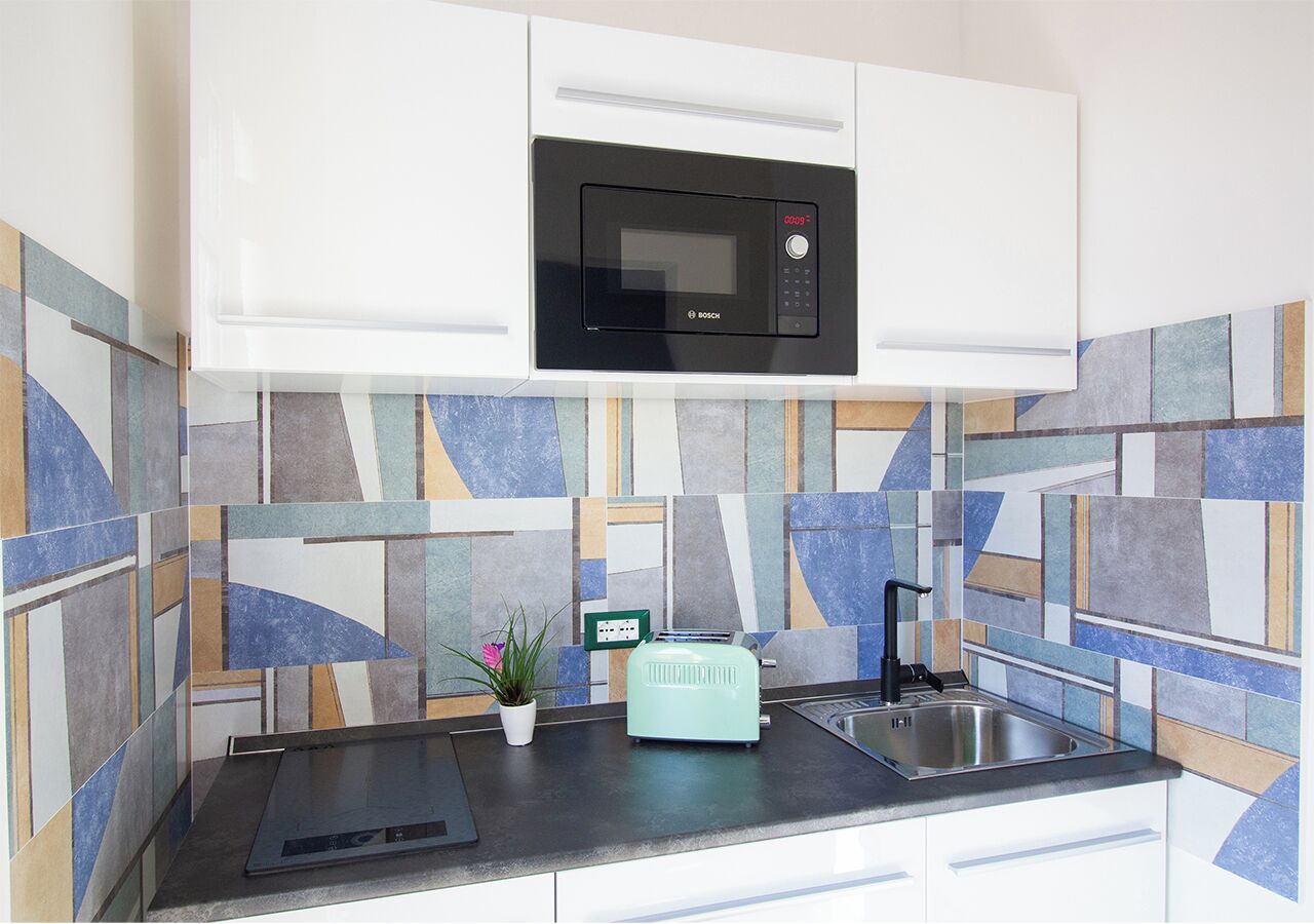 A kitchen with a Bosch microwave, a toaster, and a sink.